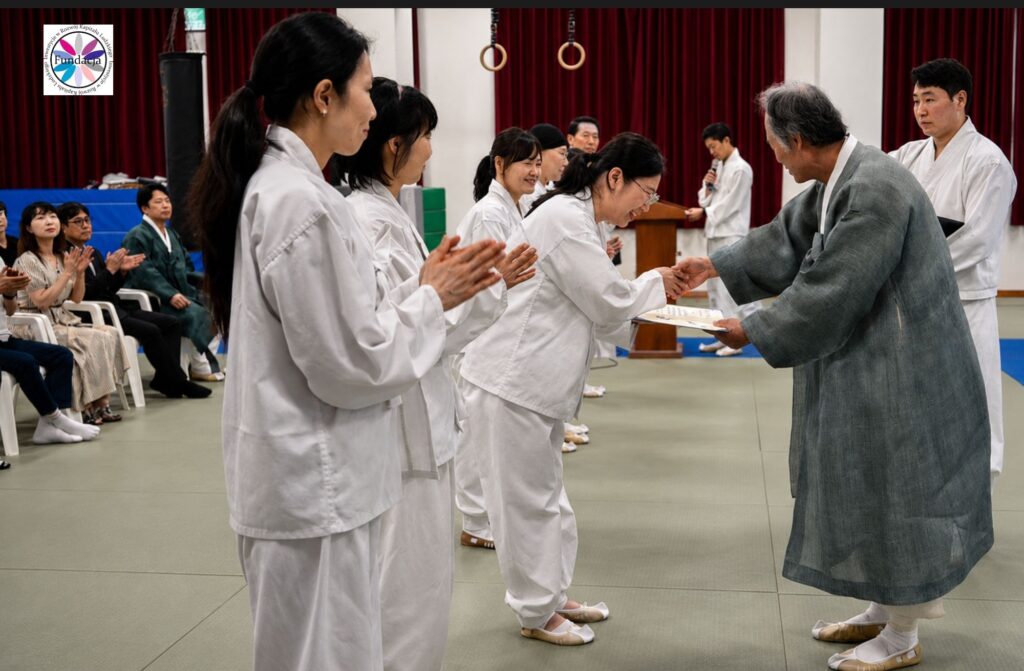 Uroczystość taekkyeon w Chungju Taekkyeonwon, wręczenie dyplomu uczestniczce przez starszego mistrza podczas ceremonii pamięci Shin Han-seunga.